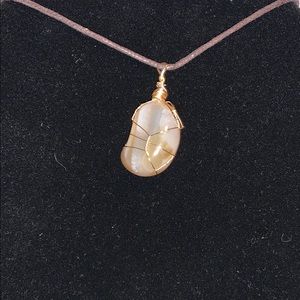 Light orange wrapped stone pendant